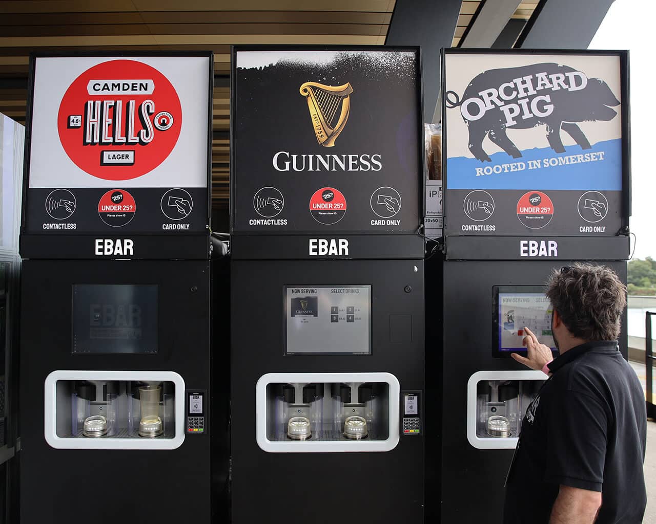 An EBar technician uses a touchscreen to test one of the three mobile EBar units he has just set up