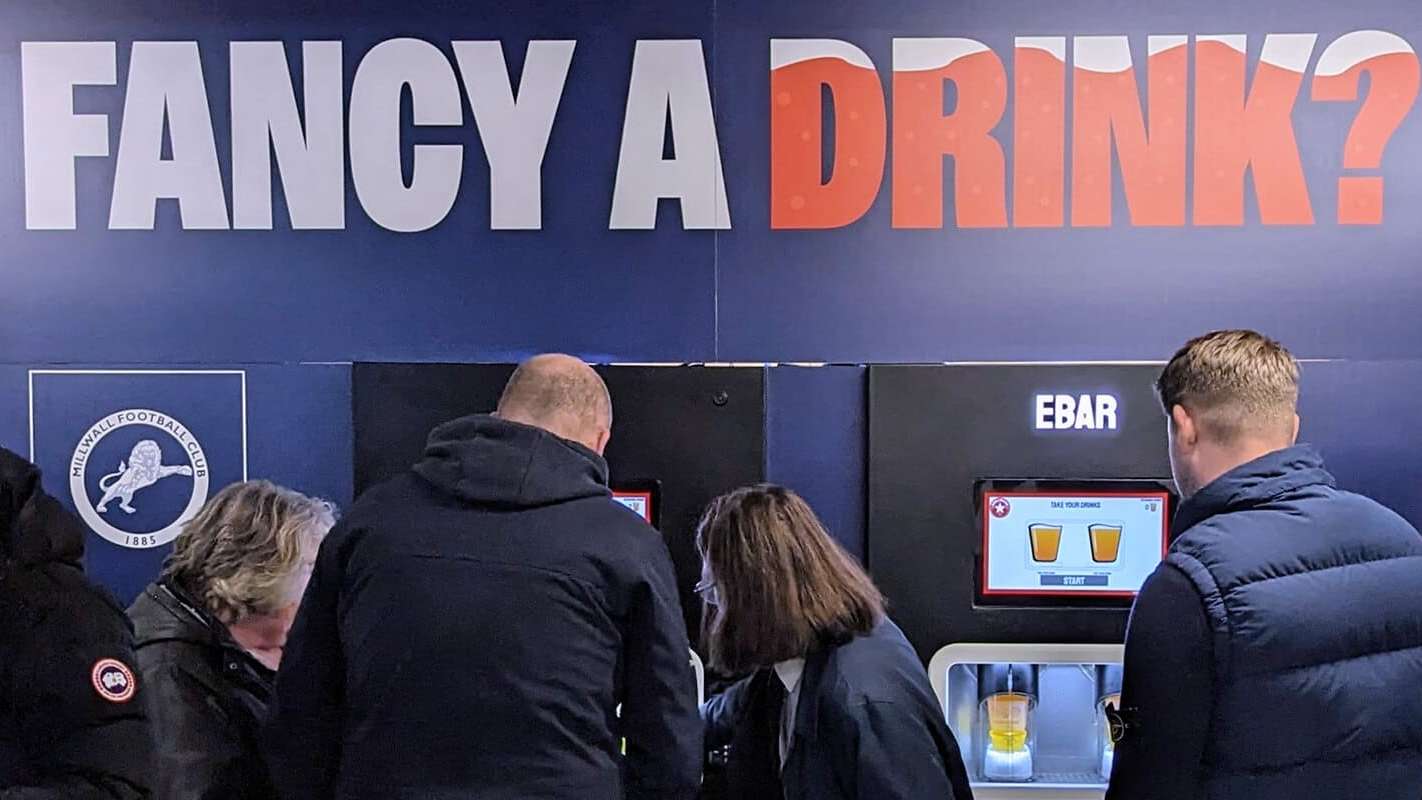 Fans making use of a club-branded 2-unit Beerwall at The Den, Millwall FC