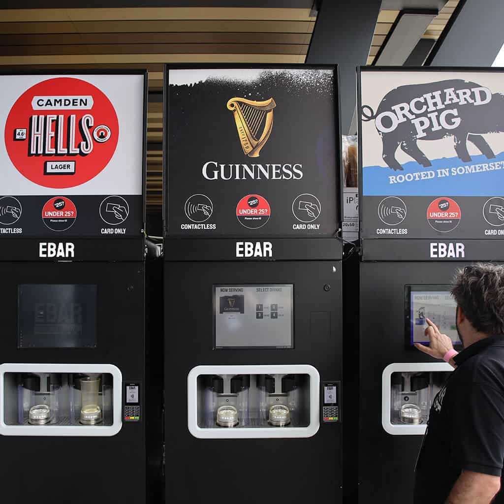 An EBar technician uses a touchscreen to test one of the three mobile EBar units he has just set up